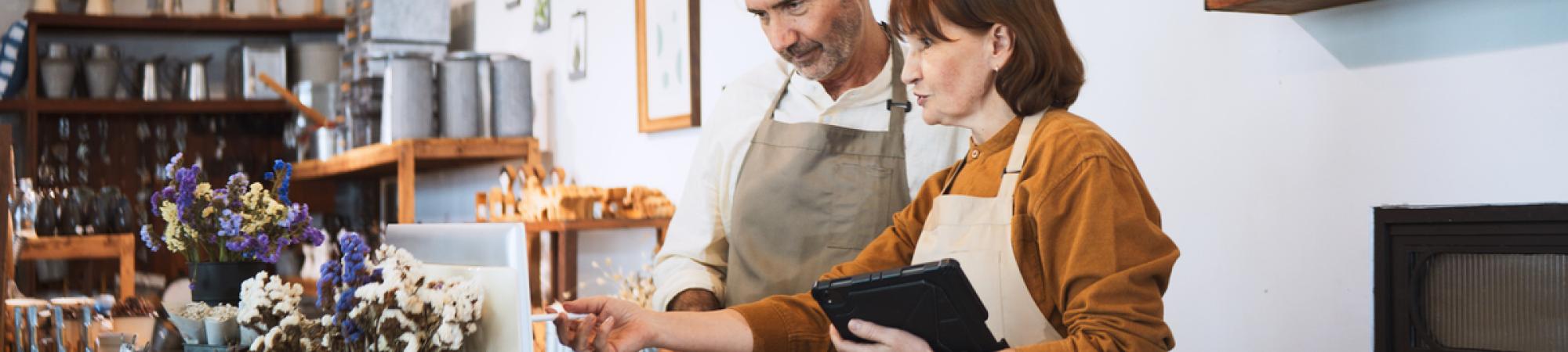Two people work at a flower shop