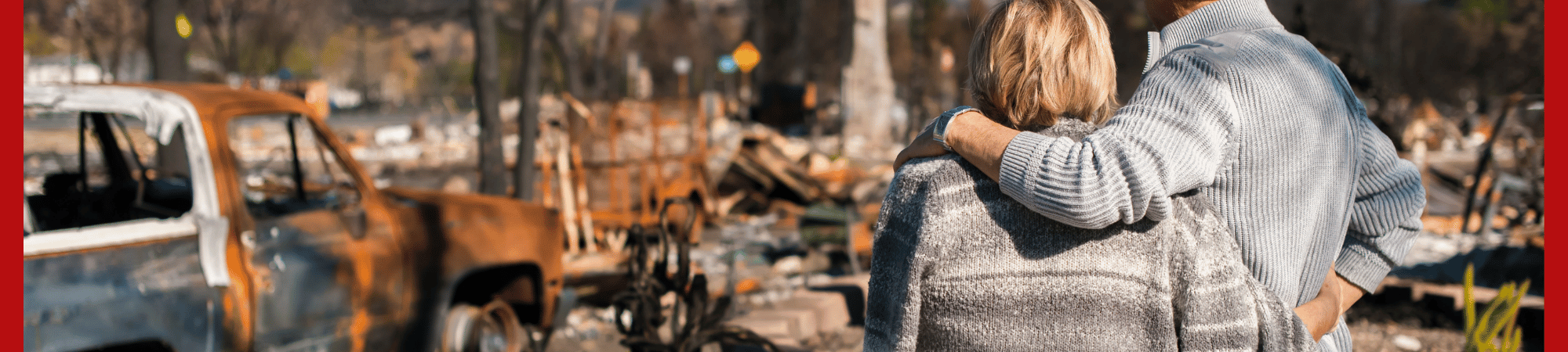 Couple looking at a disaster ravaged neighborhood